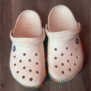 Crocs classic clogs, size 7, white with rainbow on outside.